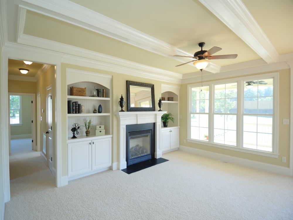 Modern living room with fireplace, large windows, and contemporary seating area